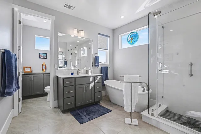 a bathroom with a tub sink and a mirror