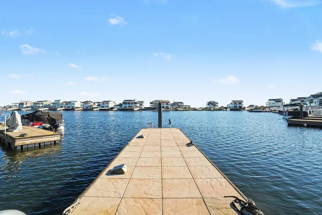 a front view of a house with a yard and lake view