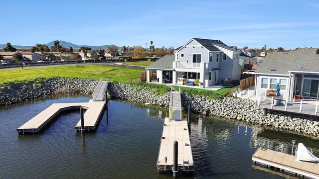 an aerial view of a house with a lake view