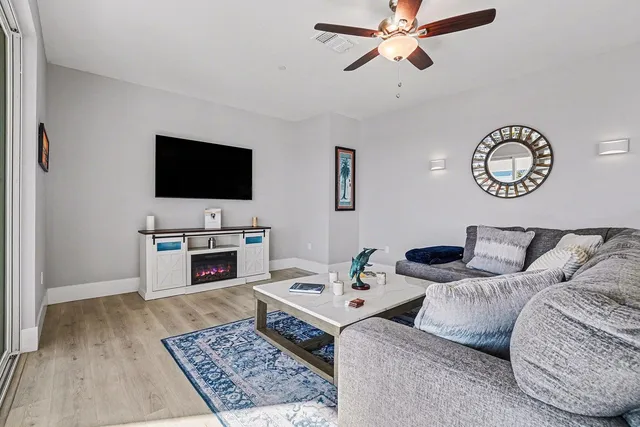 a living room with furniture and a view of kitchen