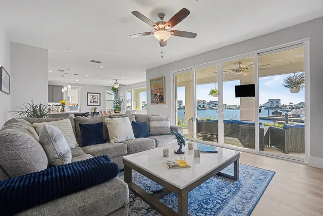 a dining room with furniture a chandelier and wooden floor