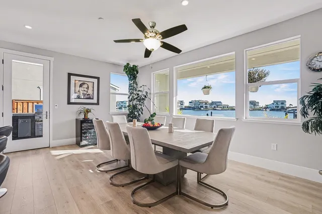 a living room with furniture a chandelier and a floor to ceiling window
