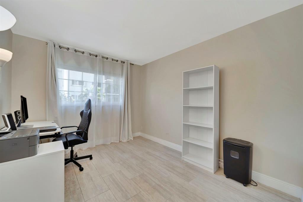3000 Northeast 5th Terrace, Unit 109A Wilton Manors, FL 33334 - Photo 12 of 36 a view of a workspace with furniture and a window