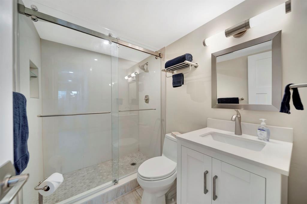 3000 Northeast 5th Terrace, Unit 109A Wilton Manors, FL 33334 - Photo 13 of 36 a bathroom with a sink toilet and shower