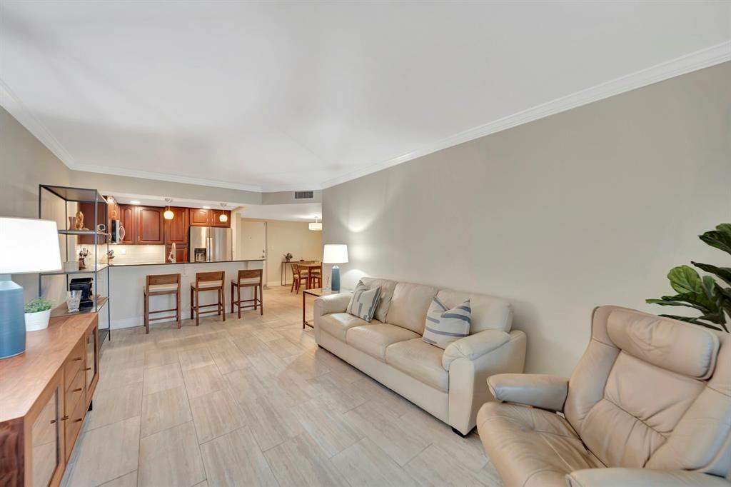 3000 Northeast 5th Terrace, Unit 109A Wilton Manors, FL 33334 - Photo 24 of 36 a living room with furniture and a table