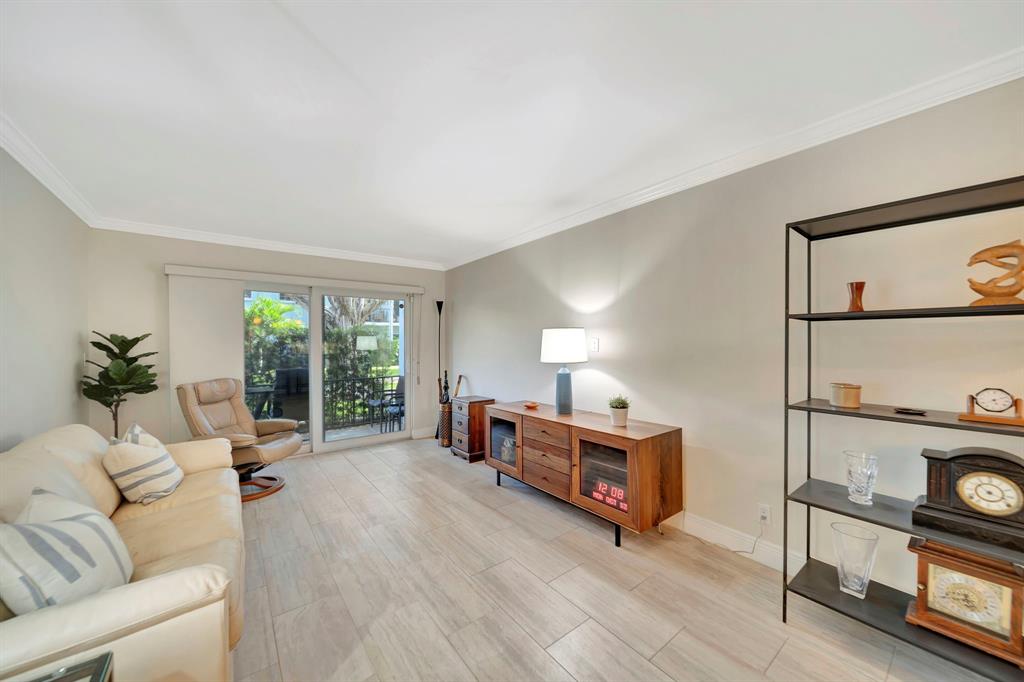 3000 Northeast 5th Terrace, Unit 109A Wilton Manors, FL 33334 - Photo 25 of 36 a living room with furniture and a flat screen tv