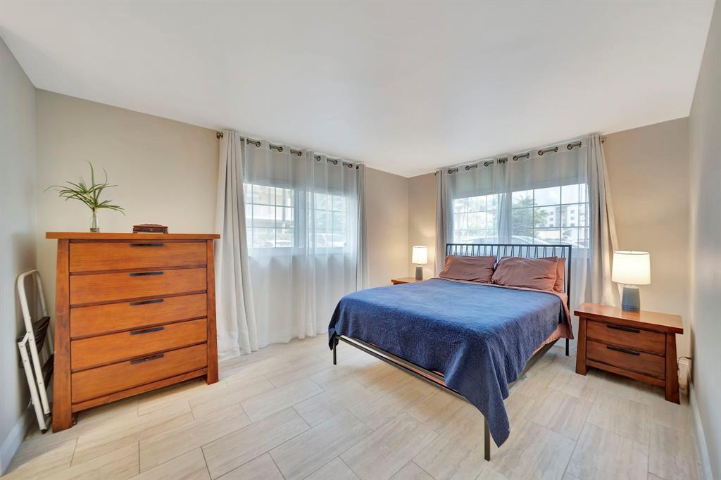 3000 Northeast 5th Terrace, Unit 109A Wilton Manors, FL 33334 - Photo 26 of 36 a bedroom with a bed and a dresser