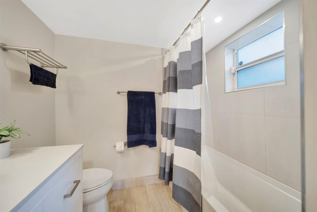 3000 Northeast 5th Terrace, Unit 109A Wilton Manors, FL 33334 - Photo 27 of 36 a bathroom with a sink a toilet and shower