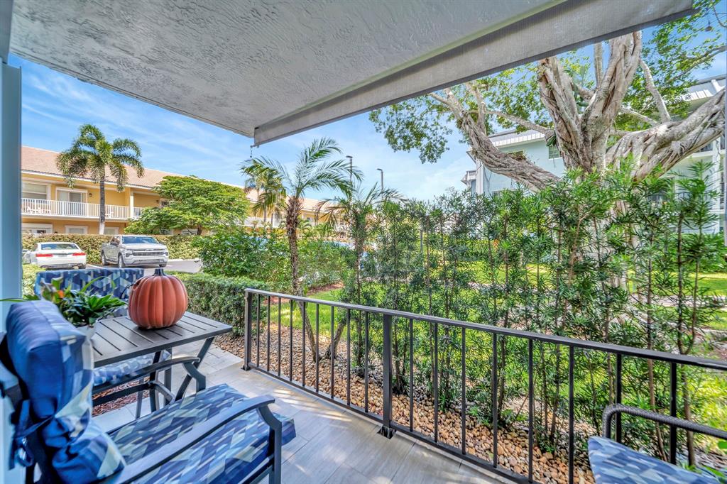 3000 Northeast 5th Terrace, Unit 109A Wilton Manors, FL 33334 - Photo 29 of 36 a balcony with wooden floor and outdoor seating