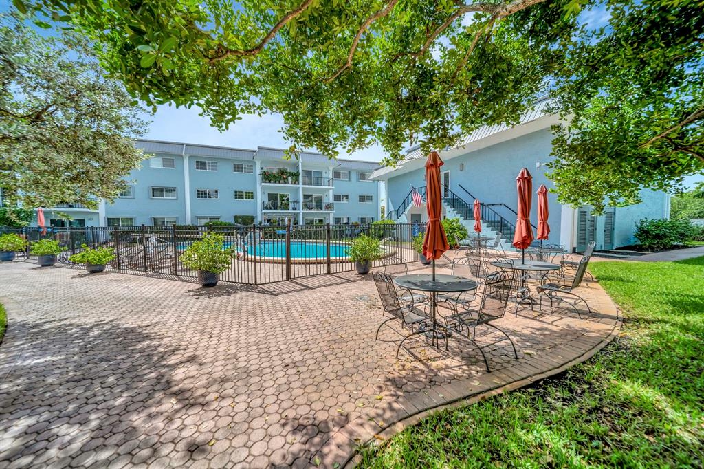 3000 Northeast 5th Terrace, Unit 109A Wilton Manors, FL 33334 - Photo 32 of 36 a view of a house with backyard and sitting area