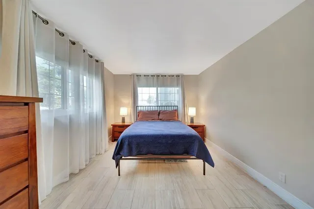 a hallway with a large window and wooden floor