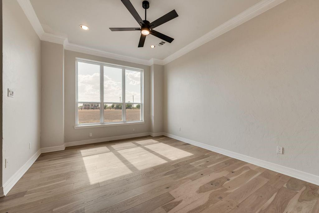 3330 Greathouse Road Waxahachie, TX 75167 - Photo 14 of 40 an empty room with wooden floor and windows