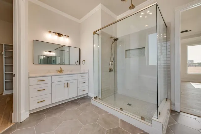 a bathroom with a shower sink mirror and shower