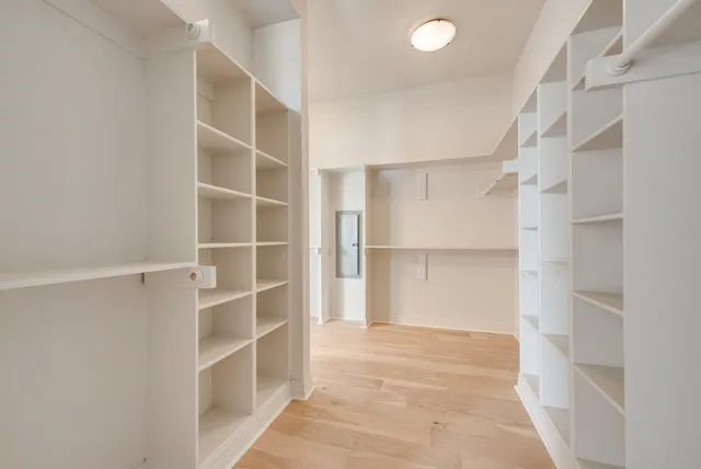a view of walk in closet with empty racks