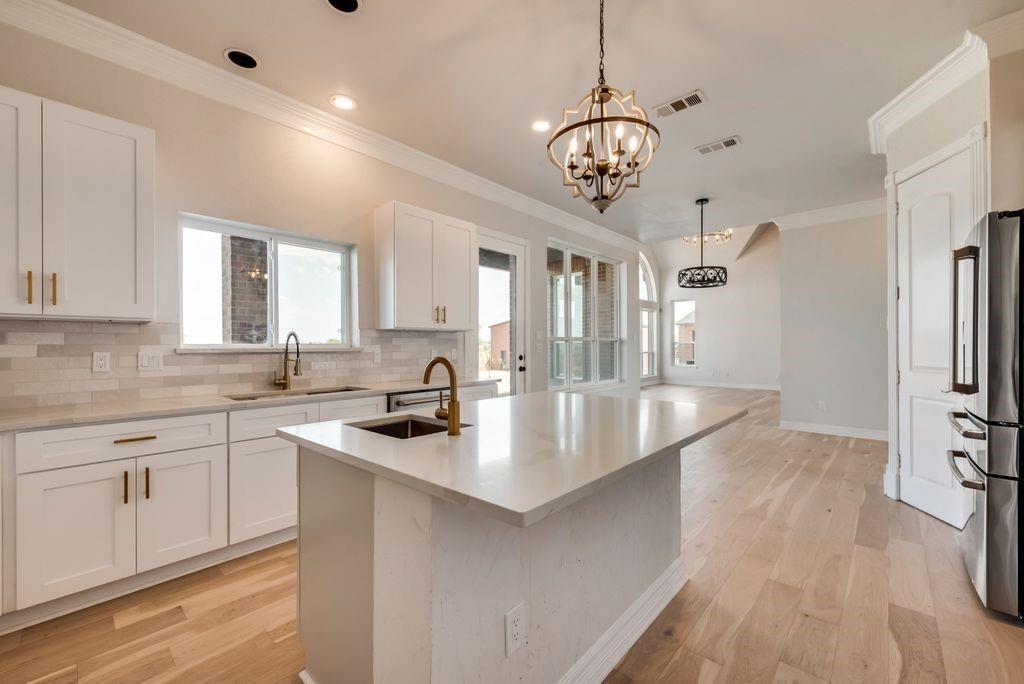 3330 Greathouse Road Waxahachie, TX 75167 - Photo 9 of 40 a kitchen with stainless steel appliances granite countertop a sink a stove and a refrigerator