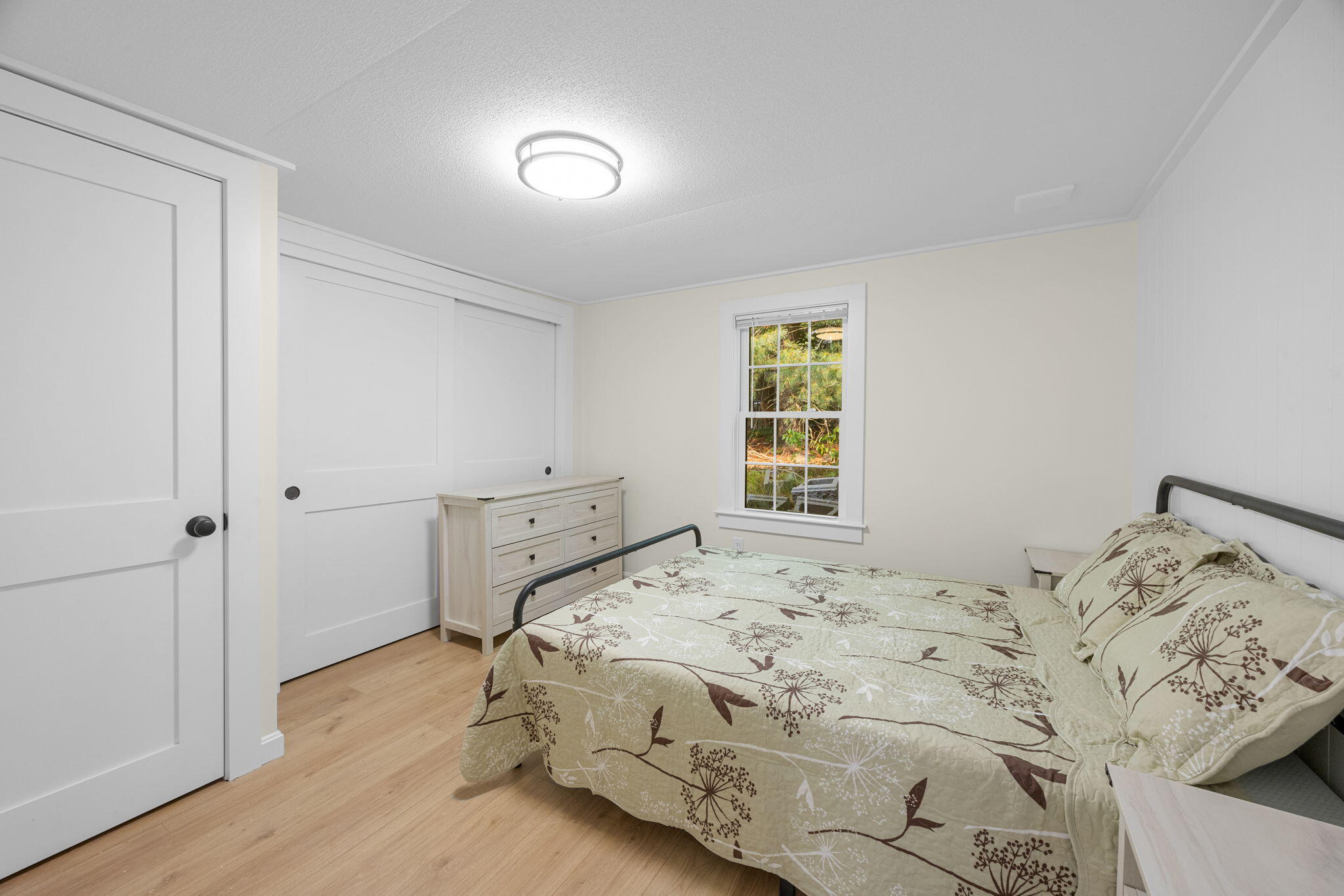 15 1st Street Bourne, MA 02559 - Photo 17 of 30 a bedroom with a bed and wooden floor