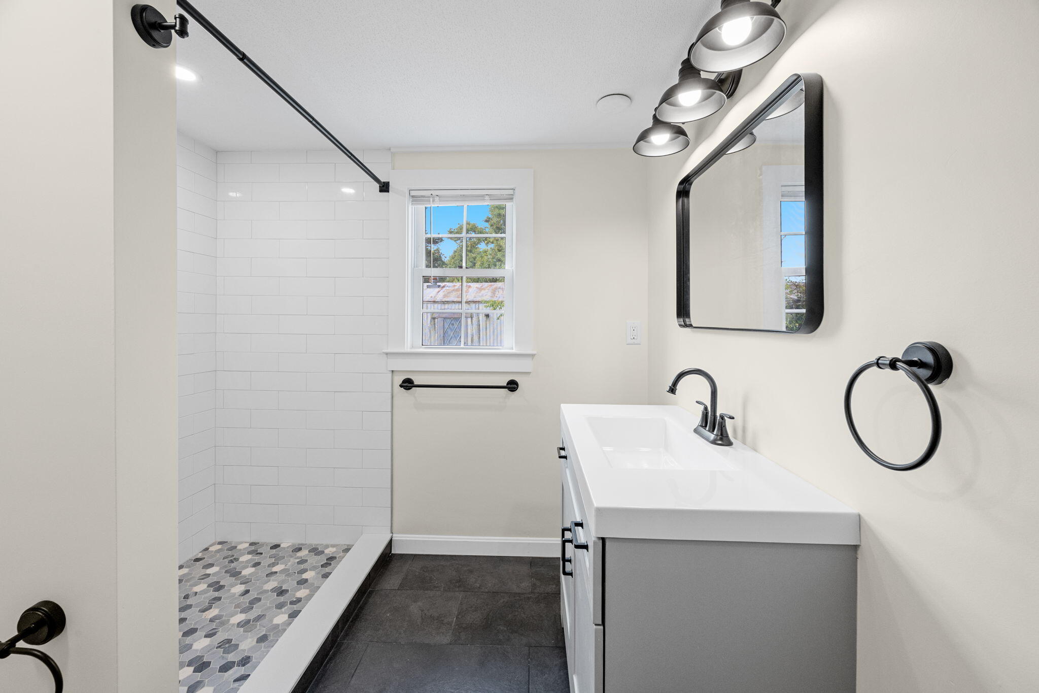 15 1st Street Bourne, MA 02559 - Photo 22 of 30 a bathroom with a toilet sink and mirror