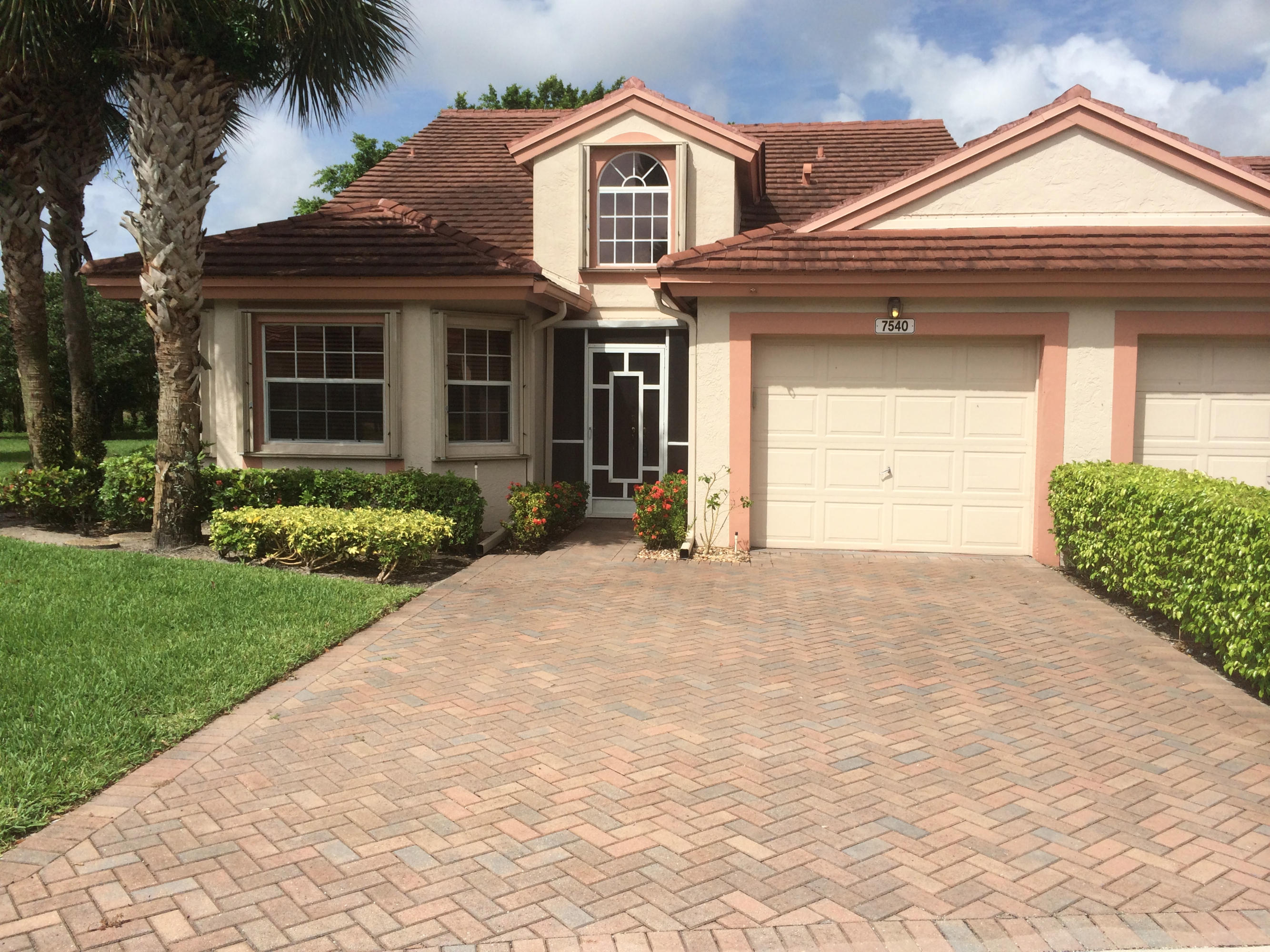 7540 Diamond Pointe Circle Delray Beach, FL 33446 - Photo 18 of 18 a front view of a house with a yard and garage