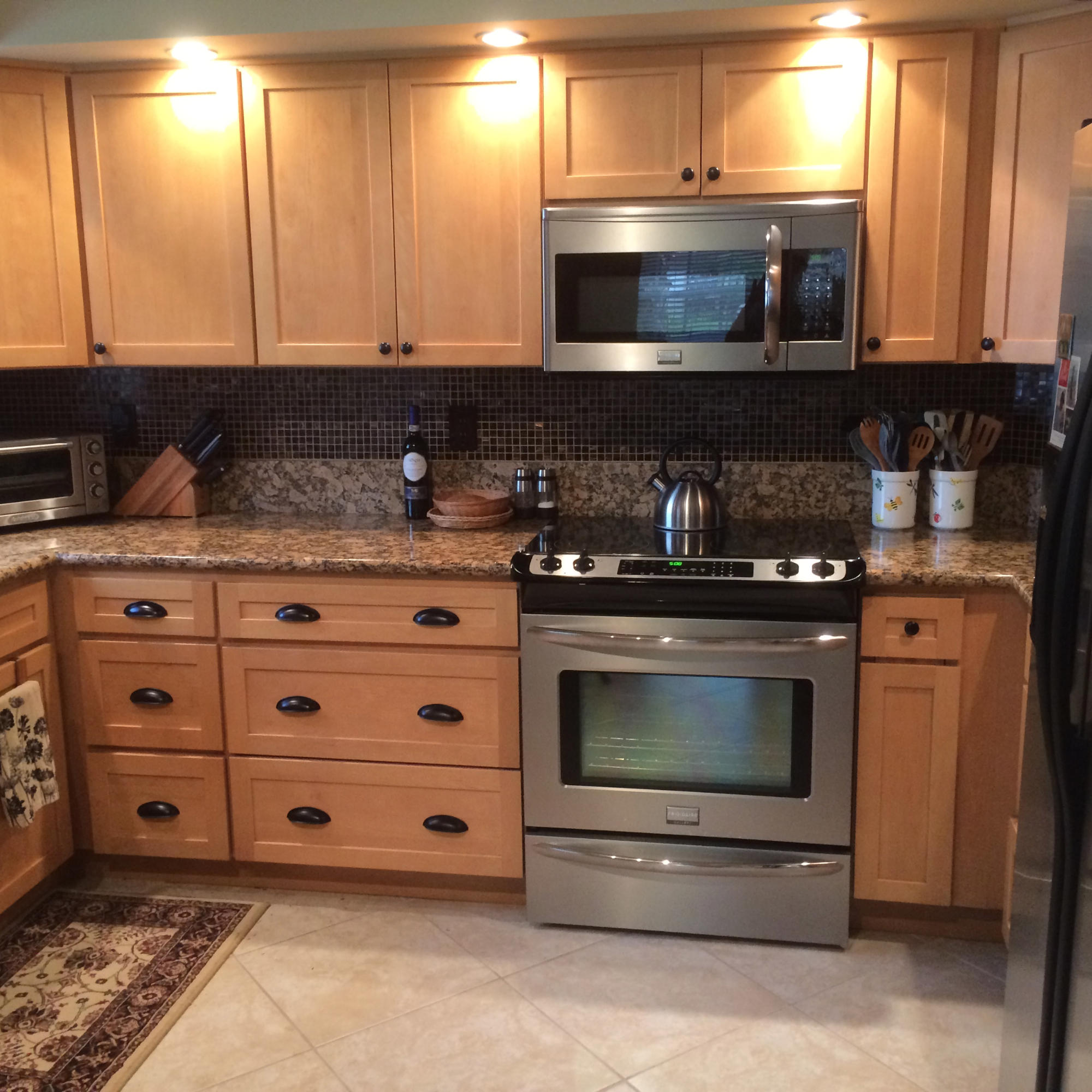 7540 Diamond Pointe Circle Delray Beach, FL 33446 - Photo 3 of 18 a kitchen with granite countertop a stove microwave and sink