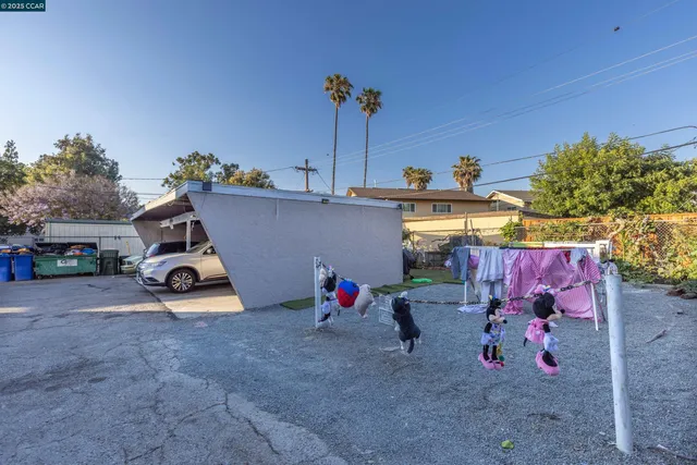 a backyard of a house with barbeque oven table and chairs