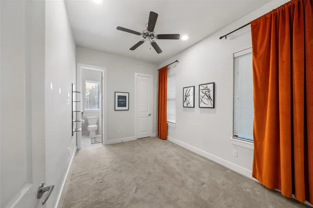 a view of a livingroom with wooden floor and a ceiling fan