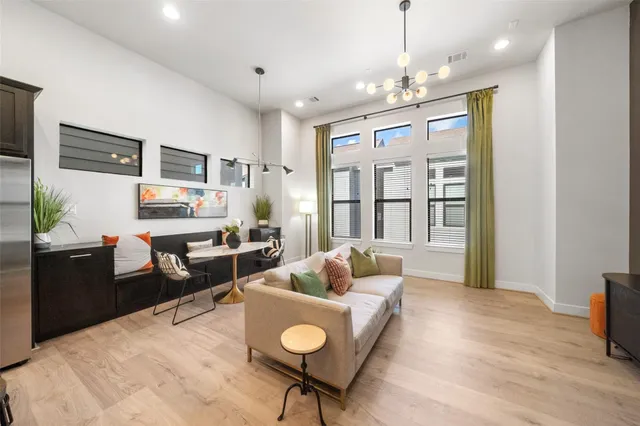 a living room with furniture and a chandelier