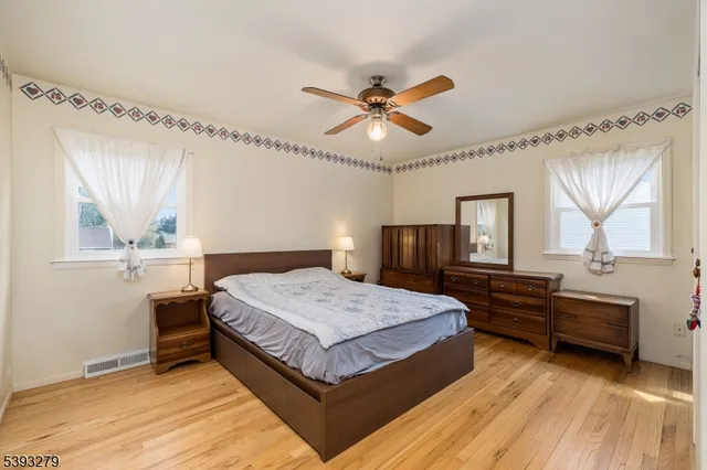 a spacious bedroom with a large bed and a chandelier