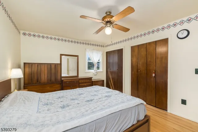 a bedroom with a large bed and a chandelier