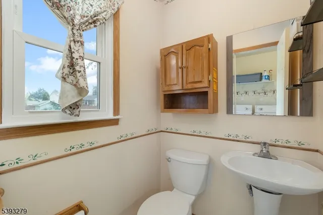 a bathroom with a toilet a sink and a window