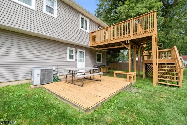 a view of a dinning tables and chairs in the back yard of the house