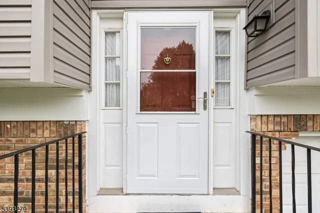 a view of a door and a window of the house