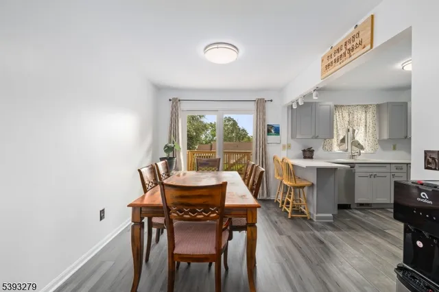 a dining room with furniture and wooden floor