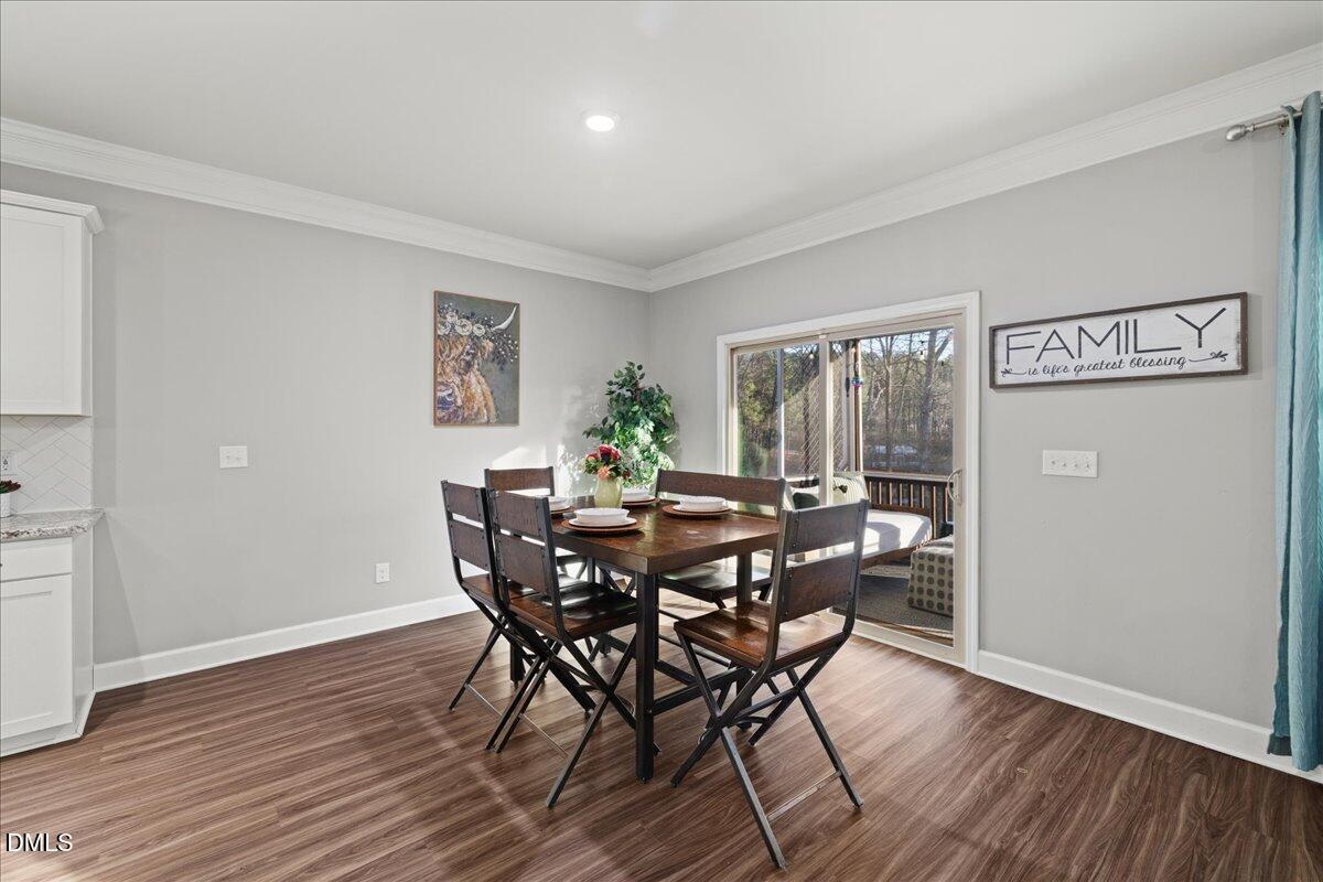 7804 Charters End Street Willow Spring, NC 27592 - Photo 8 of 43 a view of a dining room with furniture and wooden floor