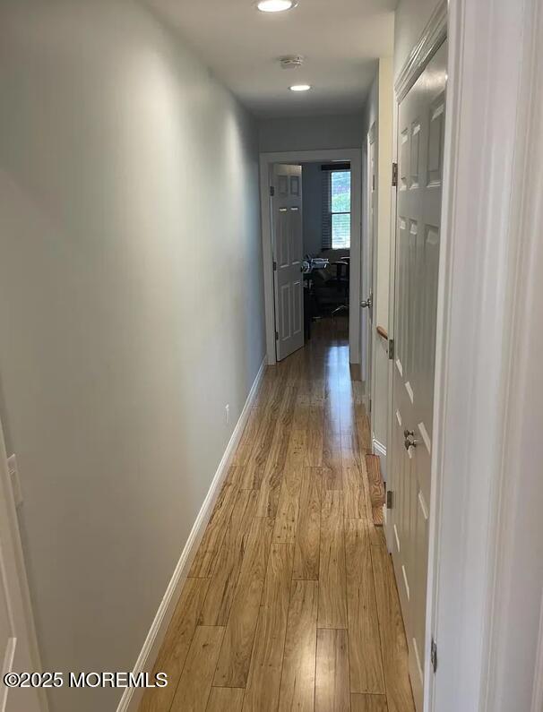 Undisclosed Address Long Branch, NJ 07740 - Photo 15 of 22 a view of a hallway with wooden floor a bathroom and a sink