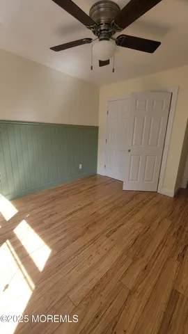 a view of a room with wooden floor