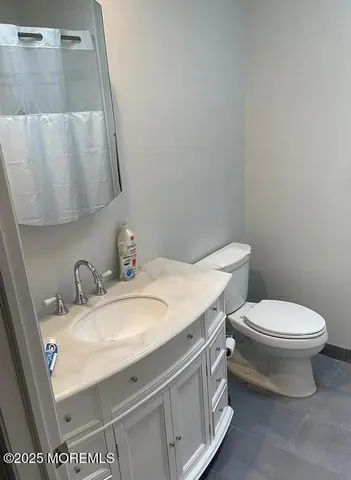 a white toilet sitting next to a bathroom sink