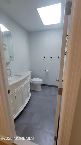 a view of a bathroom with a sink a toilet and a mirror