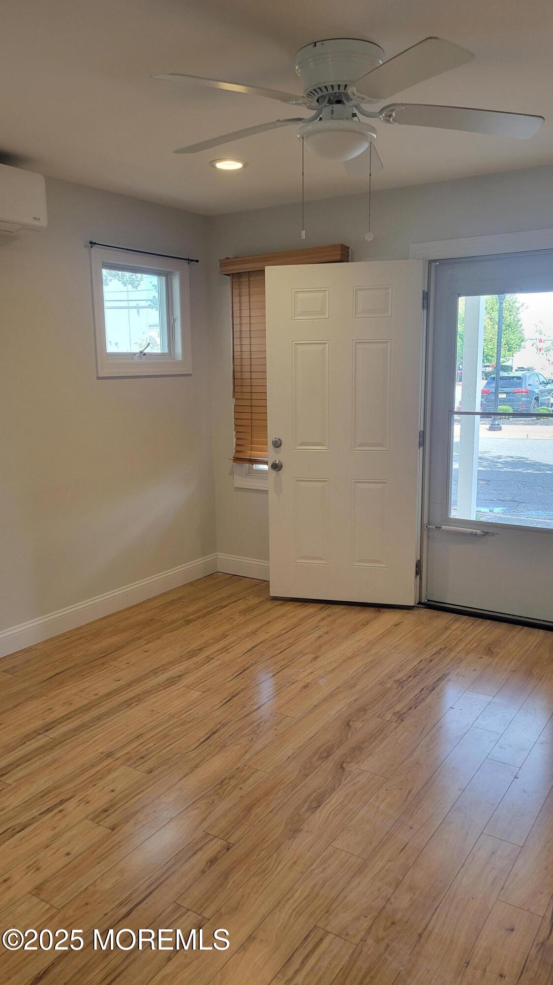 Undisclosed Address Long Branch, NJ 07740 - Photo 7 of 22 an empty room with wooden floor and windows