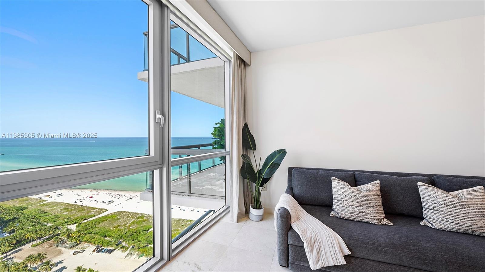 101 20th Street, Unit 3903 Miami Beach, FL 33139 - Photo 24 of 46 a bedroom with a bed and a floor to ceiling window