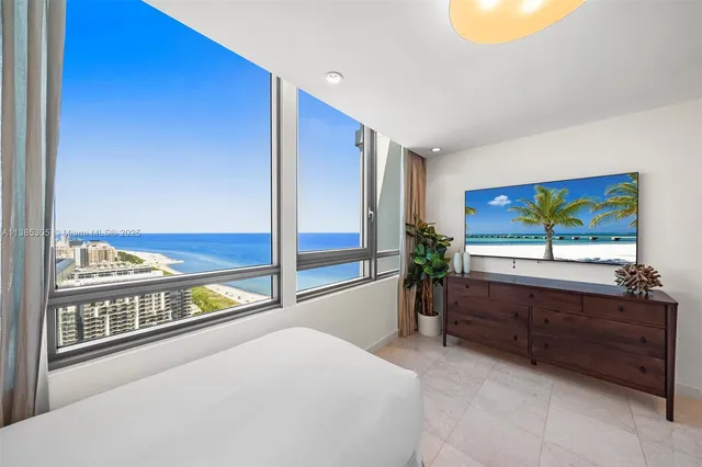 a bedroom with a bed and a potted plant