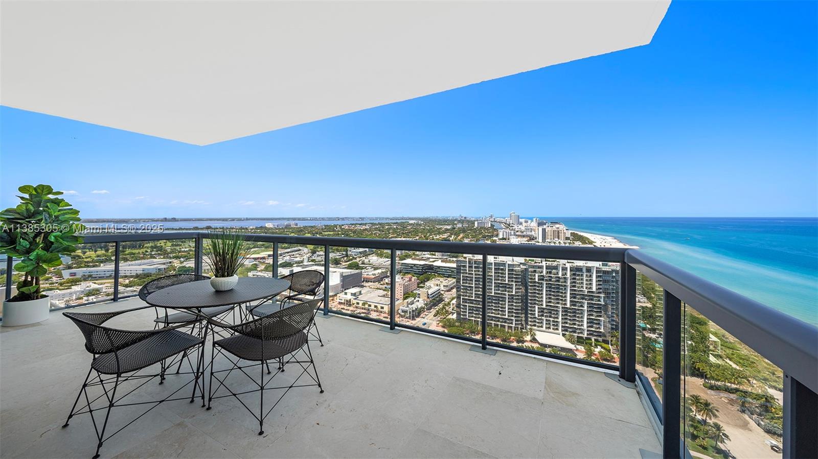 101 20th Street, Unit 3903 Miami Beach, FL 33139 - Photo 3 of 46 a view of a chairs and table in the balcony