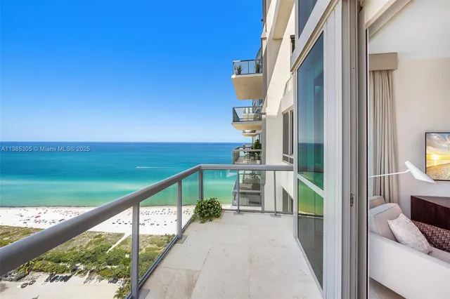 a view of a balcony with city and ocean view