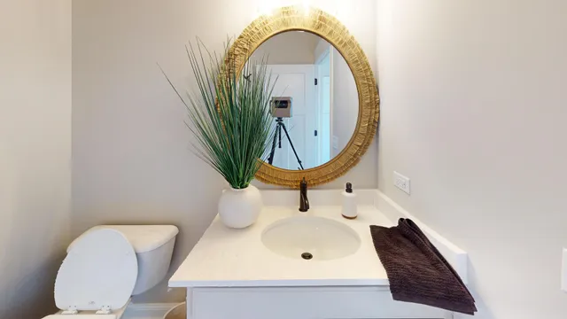 a bathroom with a sink mirror and toilet