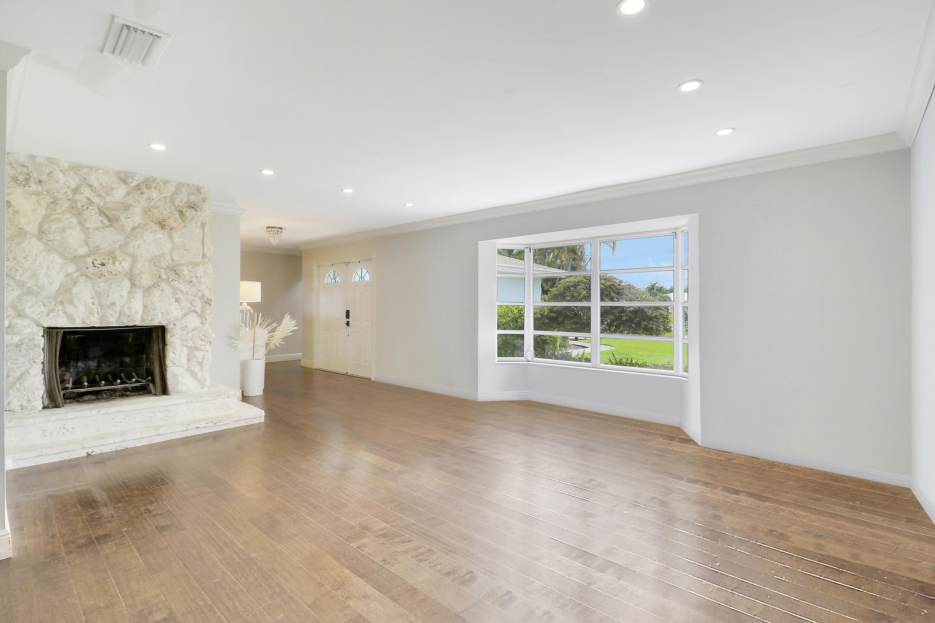 749 Cruiser Road North North Palm Beach, FL 33408 - Photo 13 of 46 a view of an empty room with a fireplace and a window