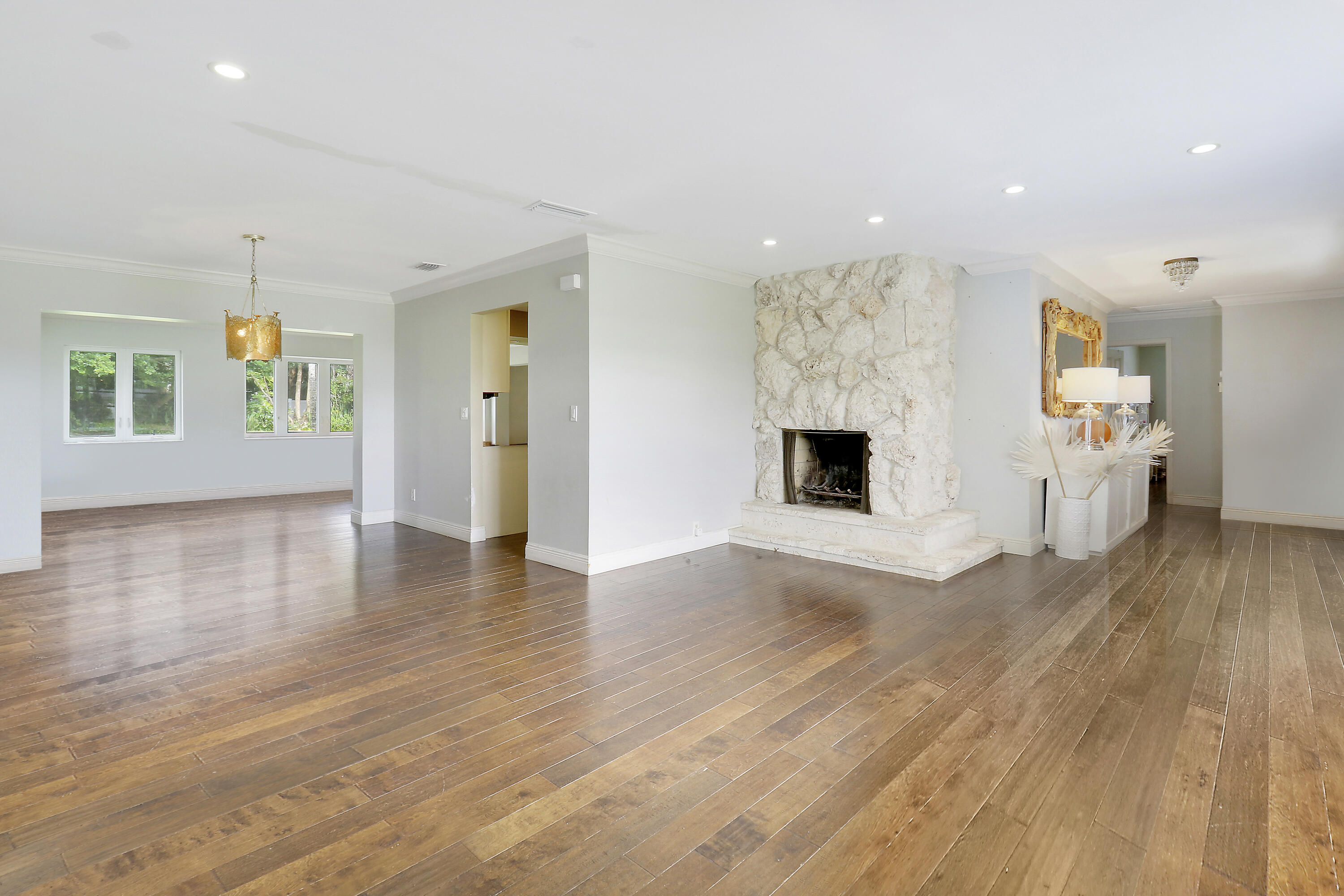749 Cruiser Road North North Palm Beach, FL 33408 - Photo 14 of 46 an empty room with wooden floor and fireplace