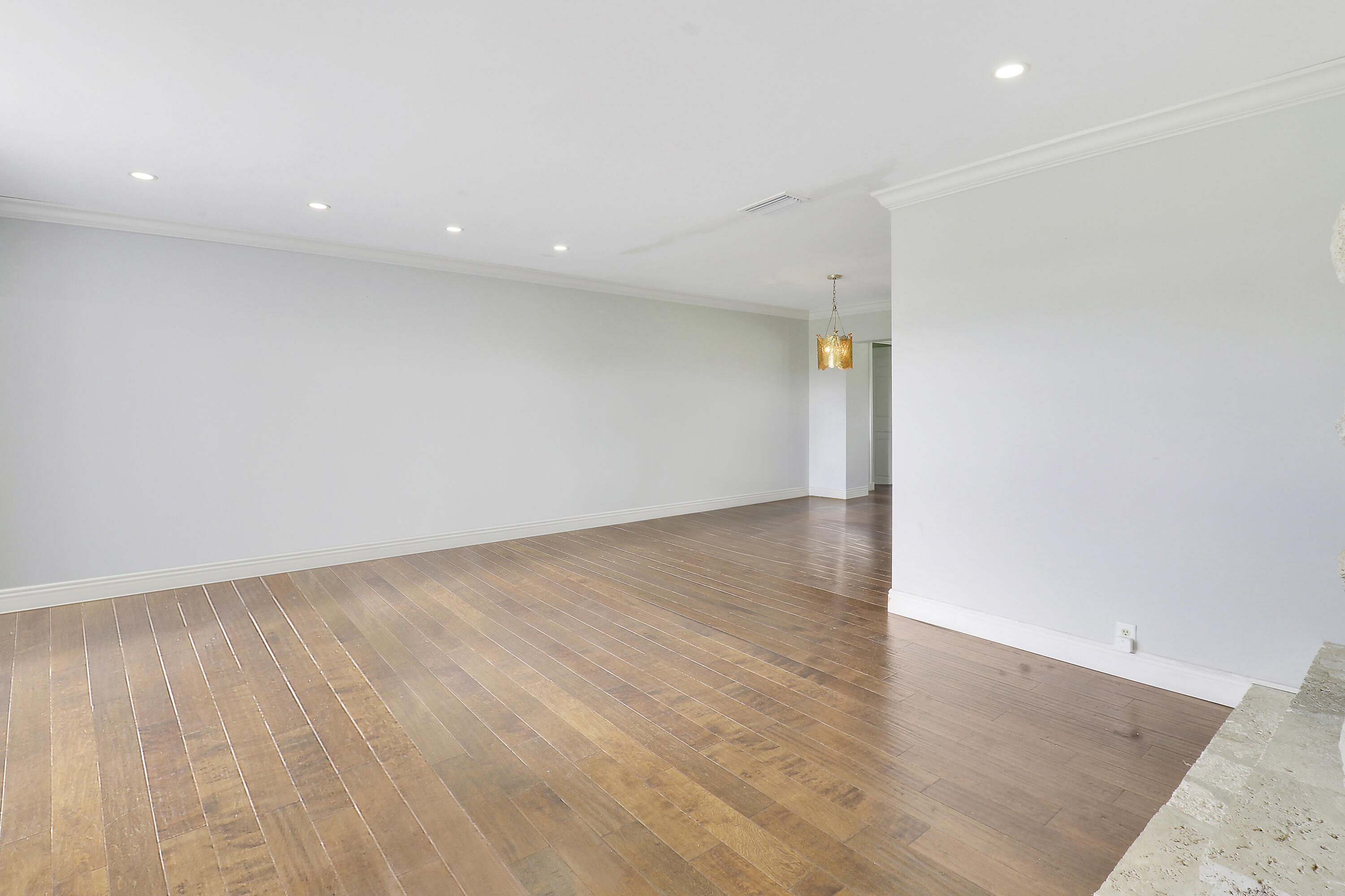 749 Cruiser Road North North Palm Beach, FL 33408 - Photo 16 of 46 an empty room with wooden floor and entrance