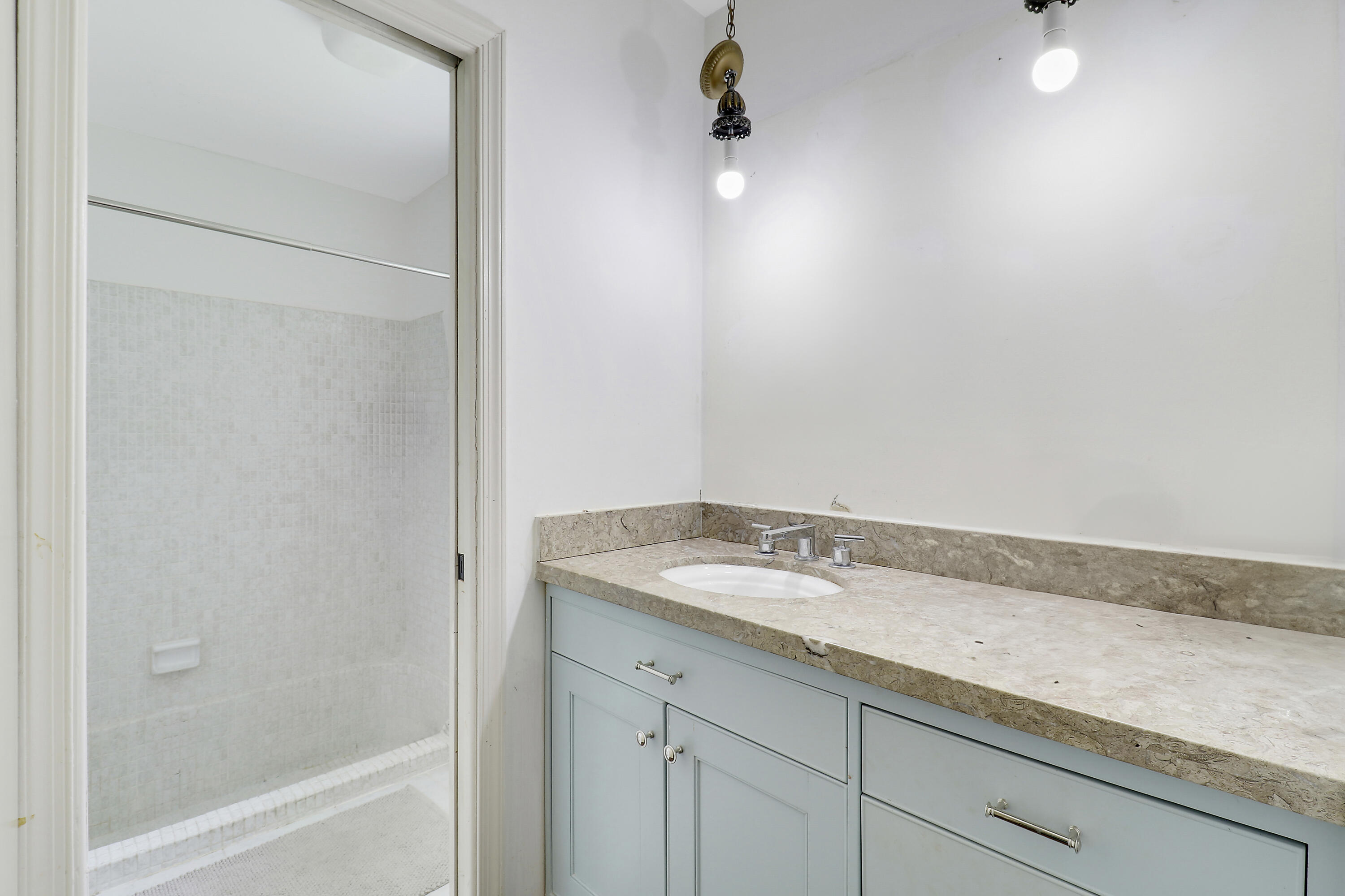 749 Cruiser Road North North Palm Beach, FL 33408 - Photo 20 of 46 a bathroom with a granite countertop sink and white cabinets