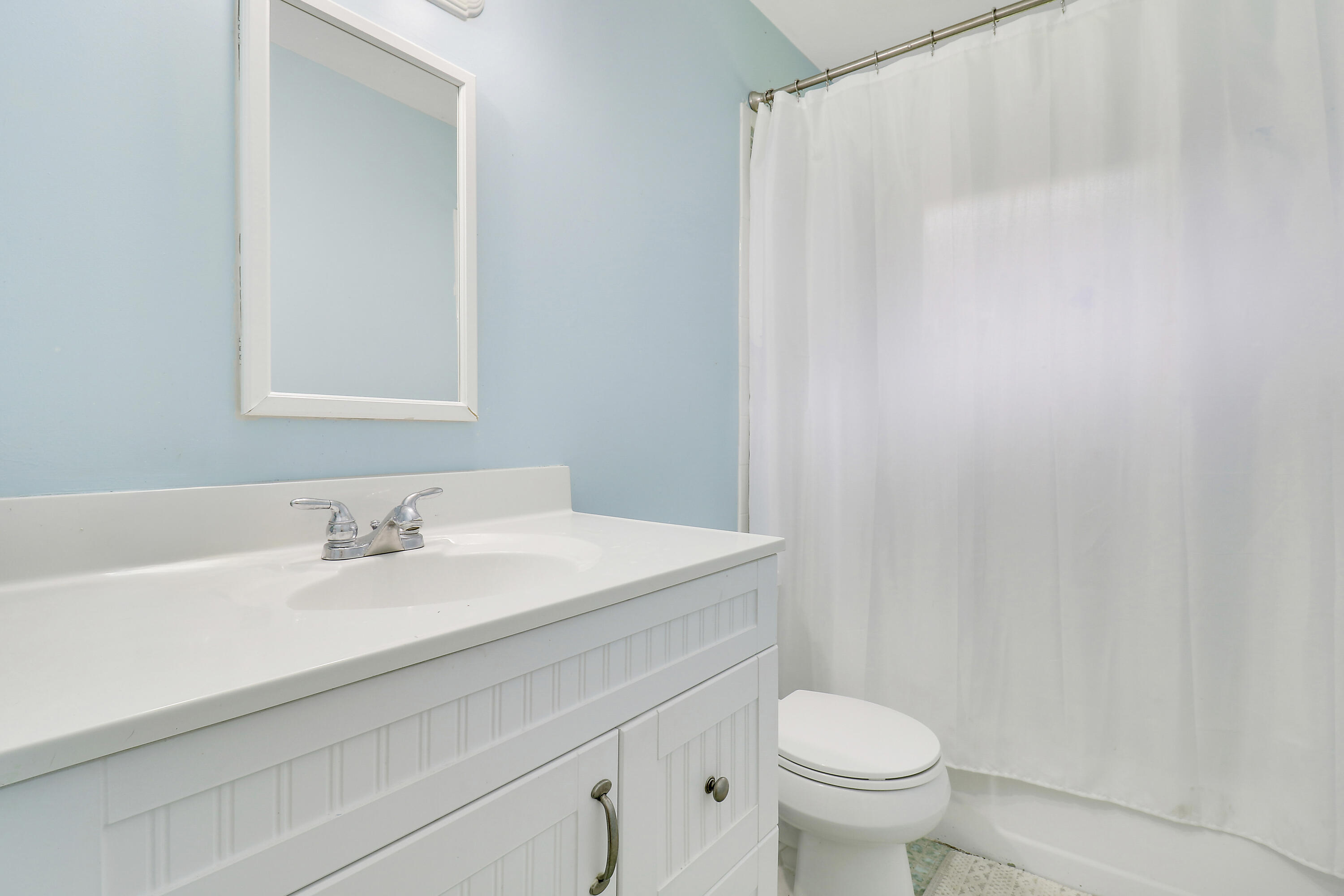749 Cruiser Road North North Palm Beach, FL 33408 - Photo 23 of 46 a bathroom with a sink toilet and a mirror