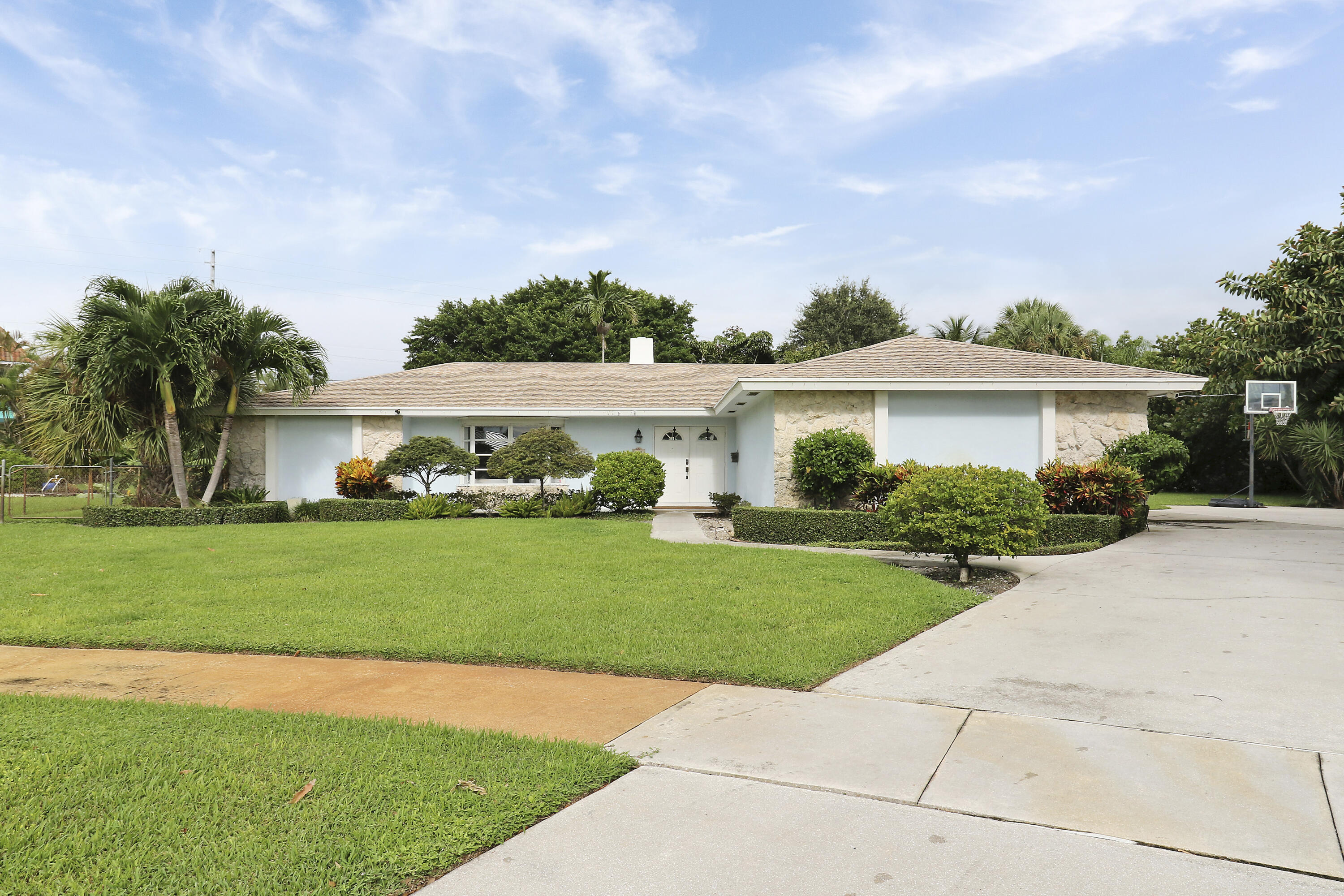 749 Cruiser Road North North Palm Beach, FL 33408 - Photo 5 of 46 a front view of house with yard and green space