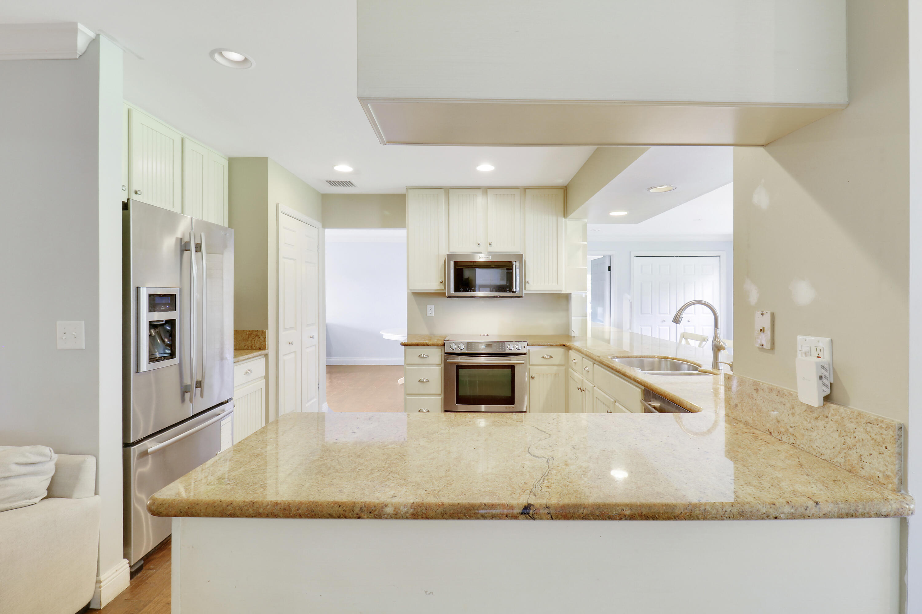 749 Cruiser Road North North Palm Beach, FL 33408 - Photo 8 of 46 a large kitchen with stainless steel appliances granite countertop a large counter top and a stove top oven